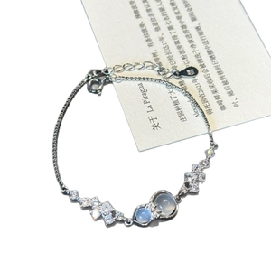Exquisite silver bracelet featuring zircon bow and blue-grey gemstone charms