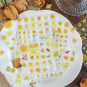 3D acrylic yellow floral stickers for DIY crafts displayed on a vintage white plate