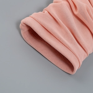 Detail shot of pink mesh fabric showing pleated texture and fine grid pattern