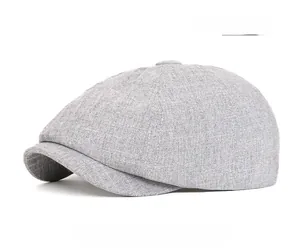 Close-up of light gray newsboy cap showing detailed linen texture and classic panel stitching