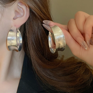 Silver brushed metal wide hoop earrings with geometric C-shape minimalist design