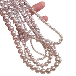 Elegant multi-strand pink purple pearl necklace with round beads in various sizes
