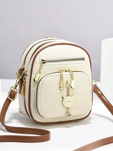 Mini lychee texture backpack in beige and brown with golden hardware and cat charm