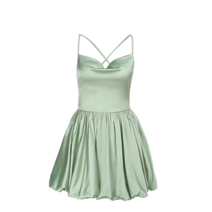 Detail of light green satin dress featuring crisscross back straps and smooth texture
