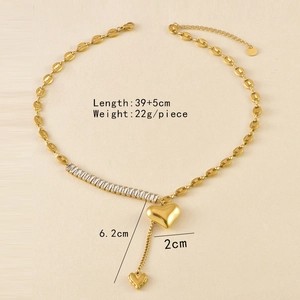 Detail of gold heart pendant with white cubic zirconia and coffee bean link chain