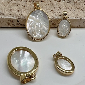 Golden Virgin Mary pendants with mother of pearl shell insets on beige stone