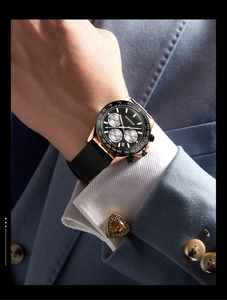 Detail shot of golden men's chronograph watch with black dial on wrist