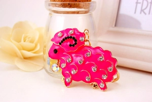 Close-up of sheep keychain with pink enamel and sparkling rhinestones for handbags