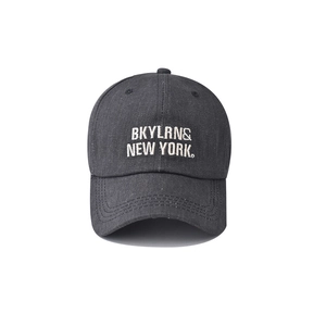 Close-up of white BKYLRN & NEW YORK embroidery on a black washed cotton baseball cap