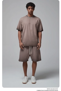 Full-body studio shot of men's vintage washed taupe knit t-shirt and matching shorts set