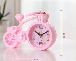Pink motorcycle-shaped alarm clock showing dimensions 11cm height and 17cm length
