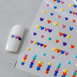 Rainbow glitter heart nail stickers with colorful 3D designs on clear adhesive backing
