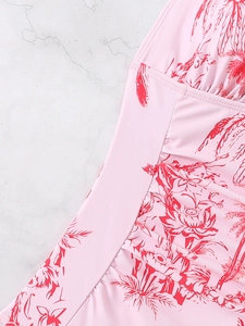 Detail of pink tropical floral print swimsuit with ruffled waist and fine stitching