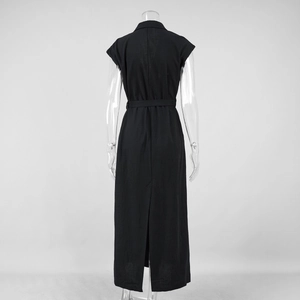 Detail view of the back slit and waist tie on this black sleeveless textured shirt dress