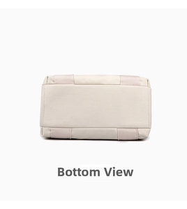 Detailed bottom view of an off-white canvas tote bag showing reinforced stitching and texture