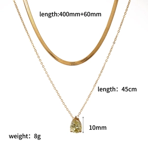 Double-layered gold necklace featuring a snake chain and a yellow teardrop gemstone pendant