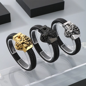 Detailed view of woven leather bracelets with lion head clasps in gold, black, and silver