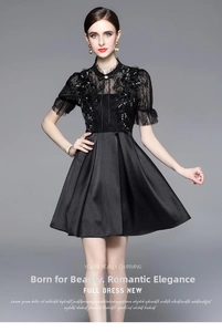 Detail of elegant black lace bodice with shimmering sequins and chic bow tie collar