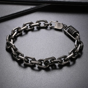 Close-up of industrial style titanium steel chain bracelet with geometric links and spring hook