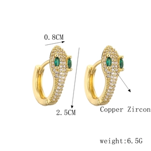 Detail showing 2.5cm golden snake hoop earrings with micro-set green zircon eyes