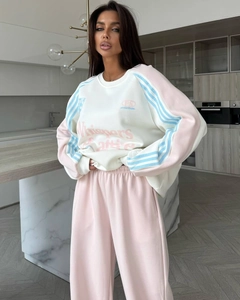 Detail of pink and white knit tracksuit with Whispers heritage lettering print