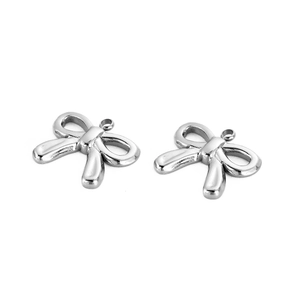 Detail of two silver bow pendants in stainless steel for DIY jewelry making