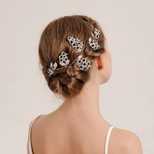 Bridal flower hair comb with silver leaf vine and monochrome petals on model hair