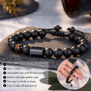 Adjustable matte onyx and tiger eye beaded bracelet for men on textured slate base