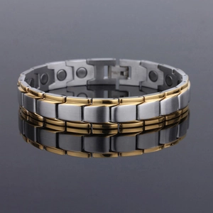 Detailed view of two-tone gold and silver magnetic steel bracelet with brushed texture