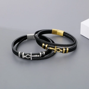 Detail of multilayer woven leather bracelet featuring gold and silver Ankh cross pendants