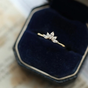Detailed close-up of golden marquise-cut gems ring set in a luxury velvet jewelry box