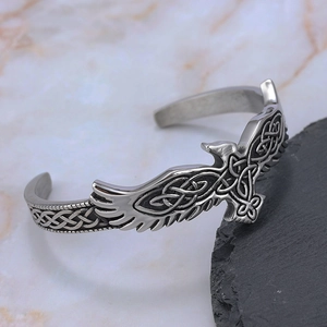 Vintage eagle stainless steel open cuff bracelet with Celtic knot textures on dark rock