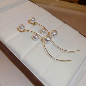 Elegant French style pearl tassel earrings with long gold curved drops for women