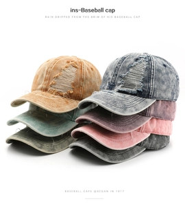 Detailed stack of distressed baseball caps in various colors with washed cotton texture