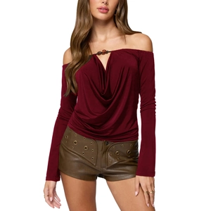 Detail of beaded cowl neckline and draped off-shoulder design on a burgundy blouse