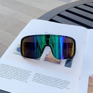 Outdoor sports sunglasses with iridescent lenses placed on a fashion magazine background