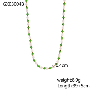 Green crystal and white pearl beaded necklace with gold spacers on white background