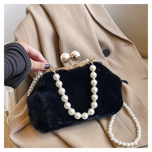 Detail view of a black faux fur handbag with elegant pearl strap and metallic shell clasp
