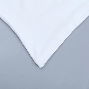 Close-up of white ribbed tank top hem showing high-quality double-needle stitching