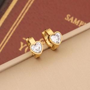 Golden heart earrings with clear zircon crystals on jewelry box display