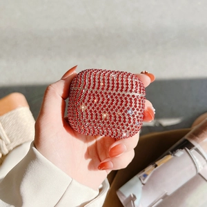 Close-up of luxury red rhinestone studded case for AirPods with sparkling crystal finish
