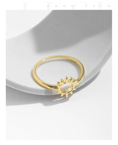 Macro view of gold s925 silver sun ring with minimalist rays on a clean background