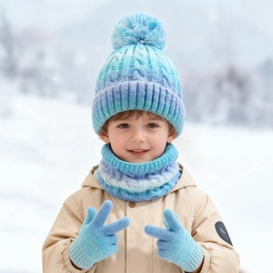 Detail of blue and purple gradient knit hat with pompom and ribbed texture for kids