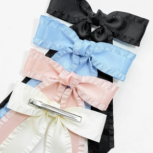 Elegant satin bow hair clips set with ruffle edges in black, pink, blue, and cream colors