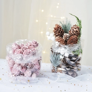 Pink and snow-flocked pine cones with green needles for Christmas tree decor