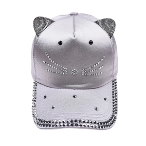 Detailed view of silver cat ear baseball cap featuring rhinestone whiskers and brim