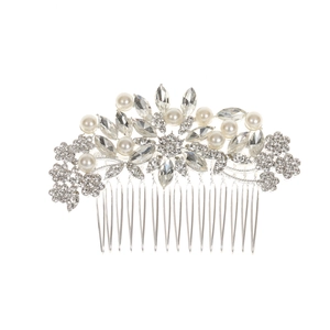Detail view of bridal hair comb featuring sparkly rhinestones and white pearls on silver alloy
