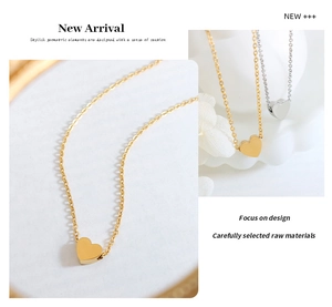 Detailed close-up of gold and silver minimalist heart pendants with polished finish
