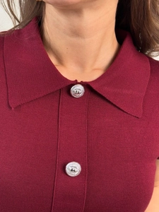 Detailed macro view of the knitted lapel collar with silver embossed decorative buttons