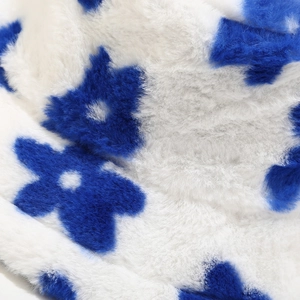 Macro detail of plush faux fur texture with blue floral pattern on winter bucket hat